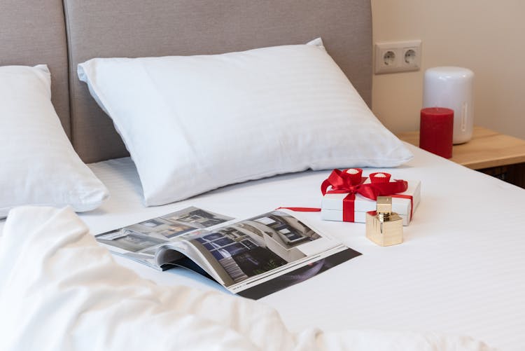 Bed With Opened Magazine With Gifts For Celebration