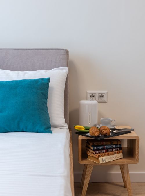 Free Croissants with cup of drink on plate with tulip flower for 8 March in bedroom Stock Photo