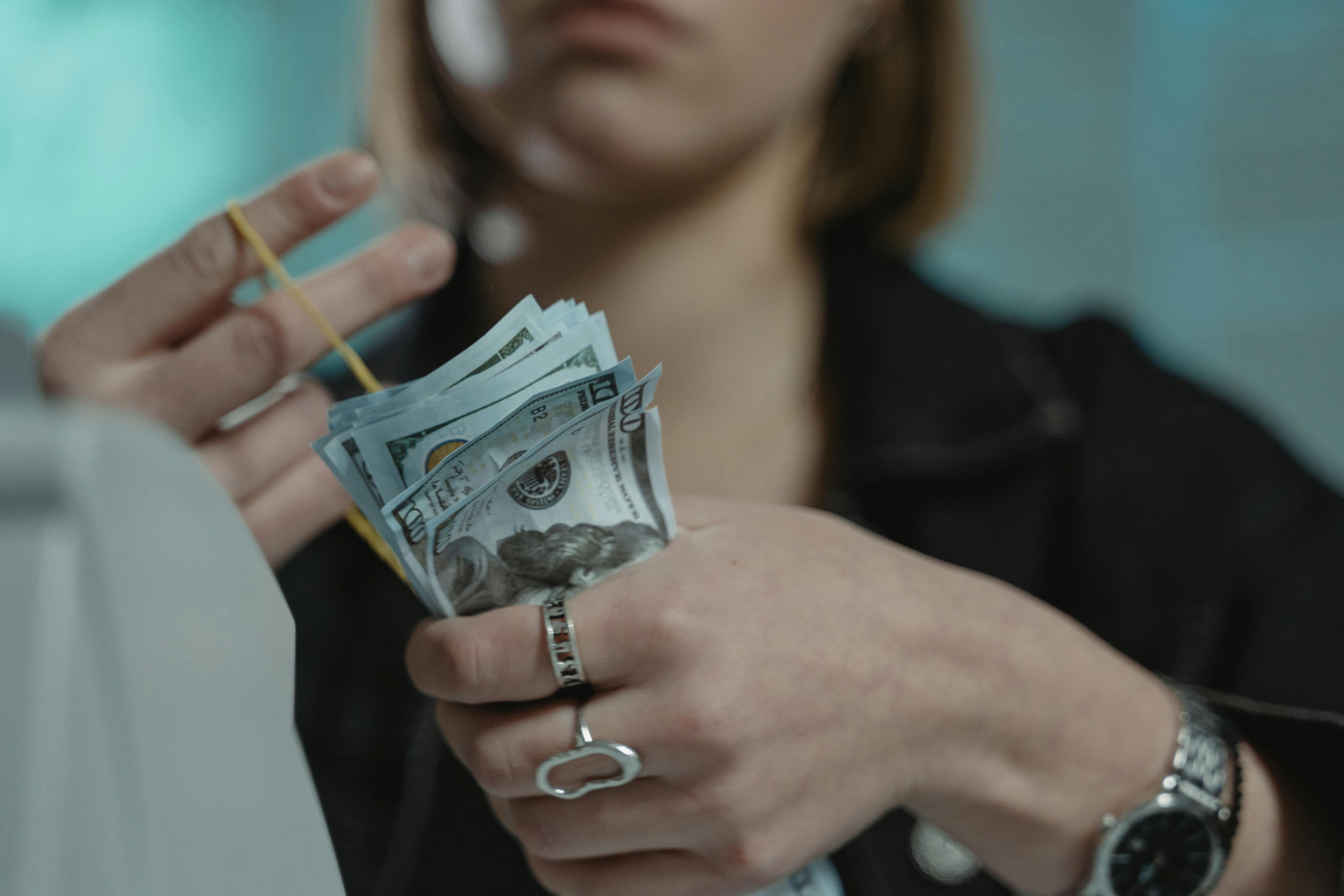 close up shot of a person holding cash money