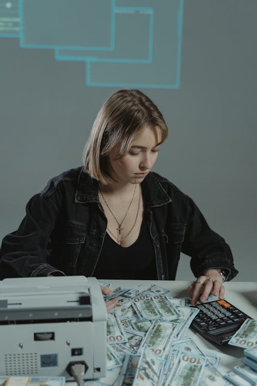 A Woman Computing Her Money