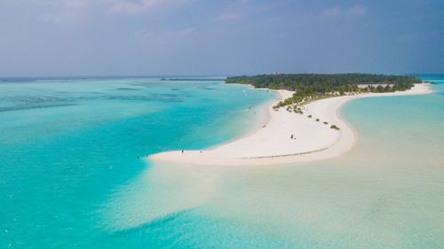 Free Discover the tranquil beauty of an untouched tropical island beach with turquoise waters and white sand. Stock Photo
