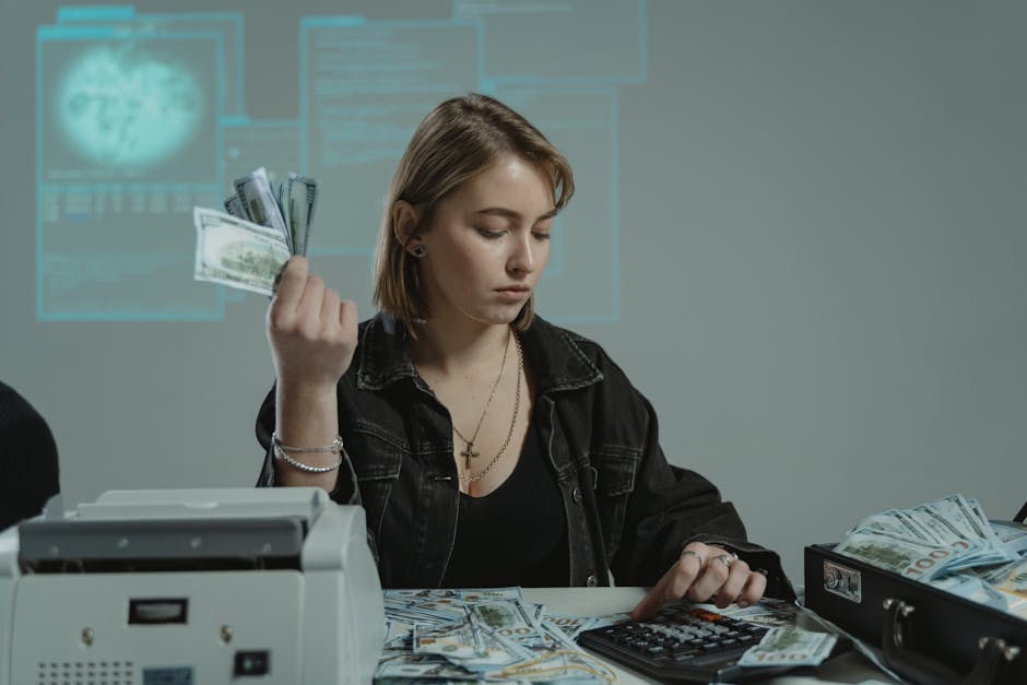 Does Wealthfront Actually Help With Idle Cash Growth? Young woman counting cash using a calculator in an office setting, surrounded by money.