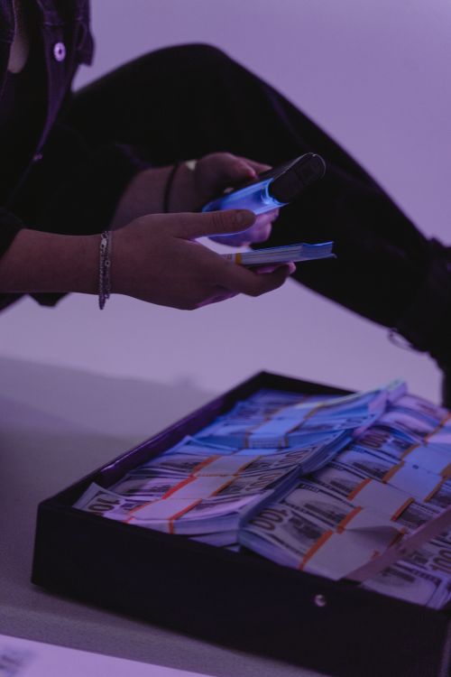 Free Close-up of currency bundles inspected under ultraviolet light, reflecting security checks. Stock Photo