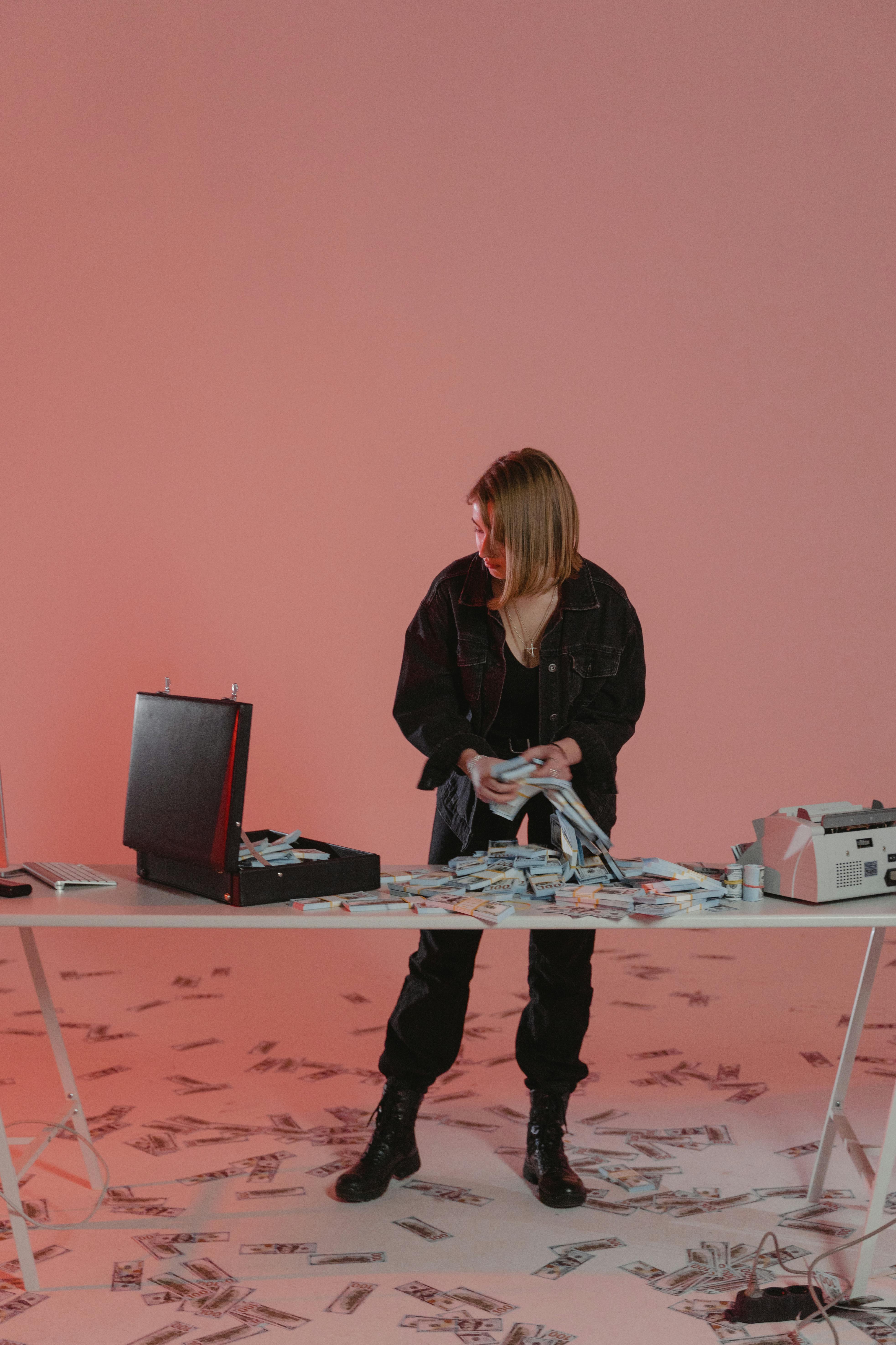 woman in black jacket standing beside table