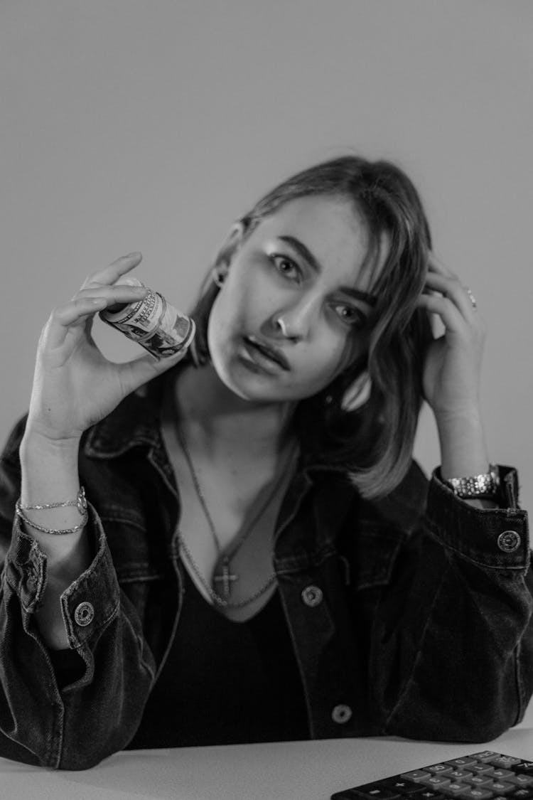 Monochrome Photo Of Woman In Black Denim Jacket Holding A Cash Money