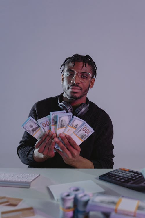 Free A Man Showing Bundles of Cash Money Stock Photo