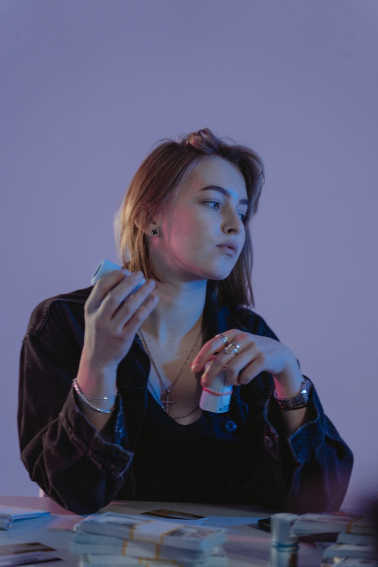 Woman In Black Denim Jacket Holding Bundles Of Money