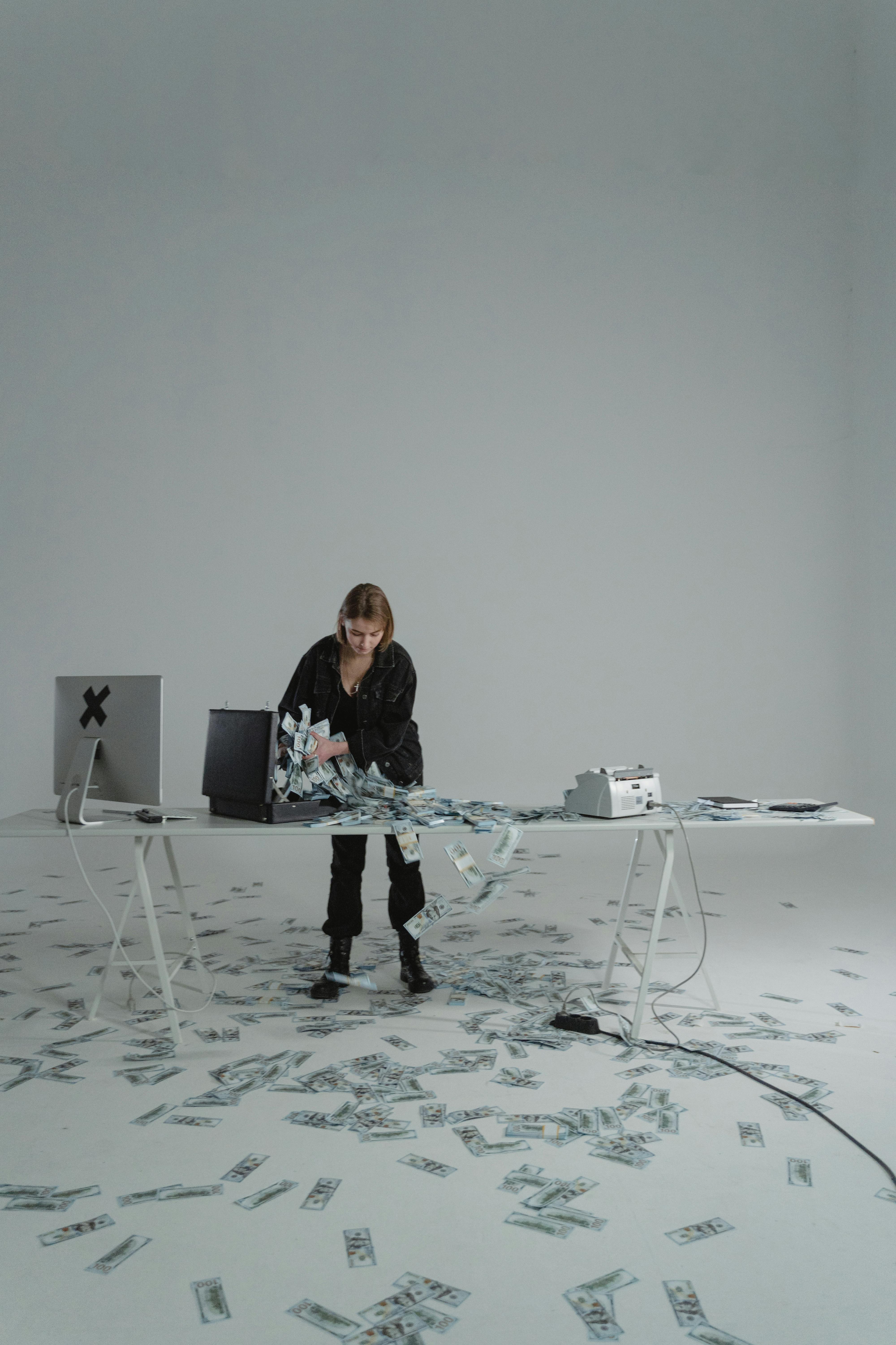 woman putting cash money in a briefcase