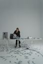 Woman Putting Cash Money in a Briefcase