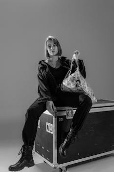 Black and white portrait of a woman sitting with a money-filled bag.