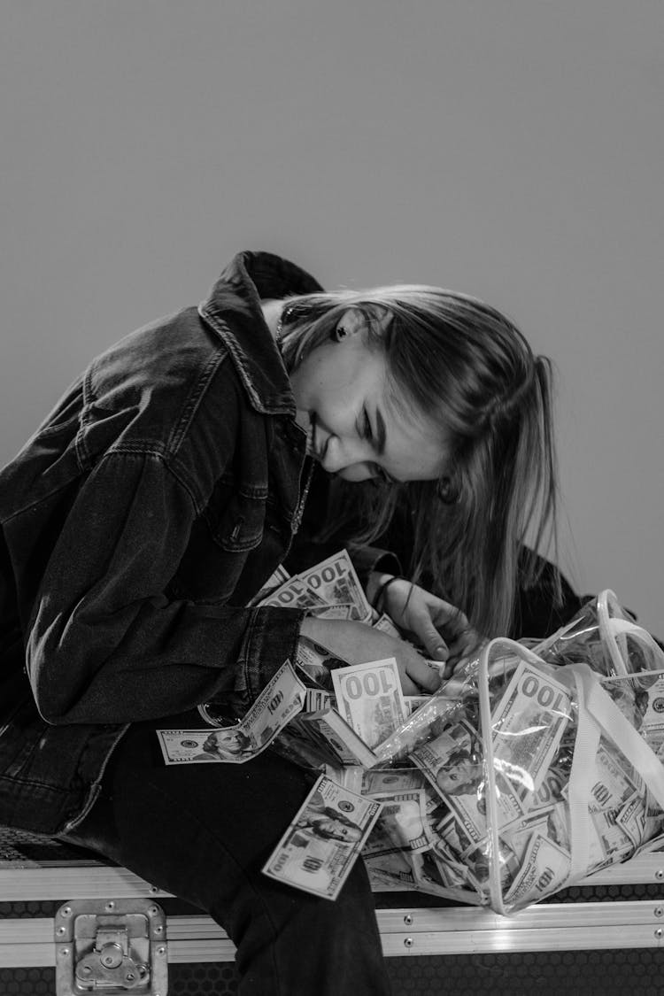 Woman Smiling Holding A Bag Of Cash Money