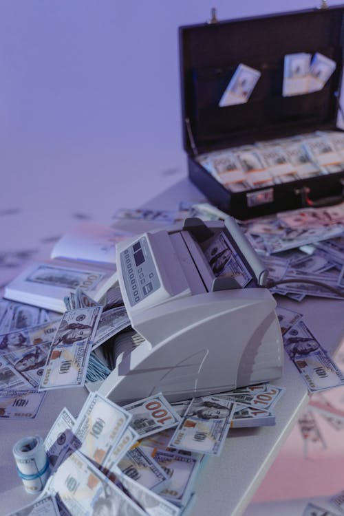 Free Money Counter Machine and a Suitcase with Cash Money Stock Photo