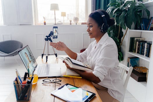 Woman engaged in a video conference, working remotely with laptop and tablet in a cozy home office.