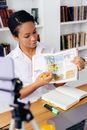Woman Pointing Yellow Stick on Book Page