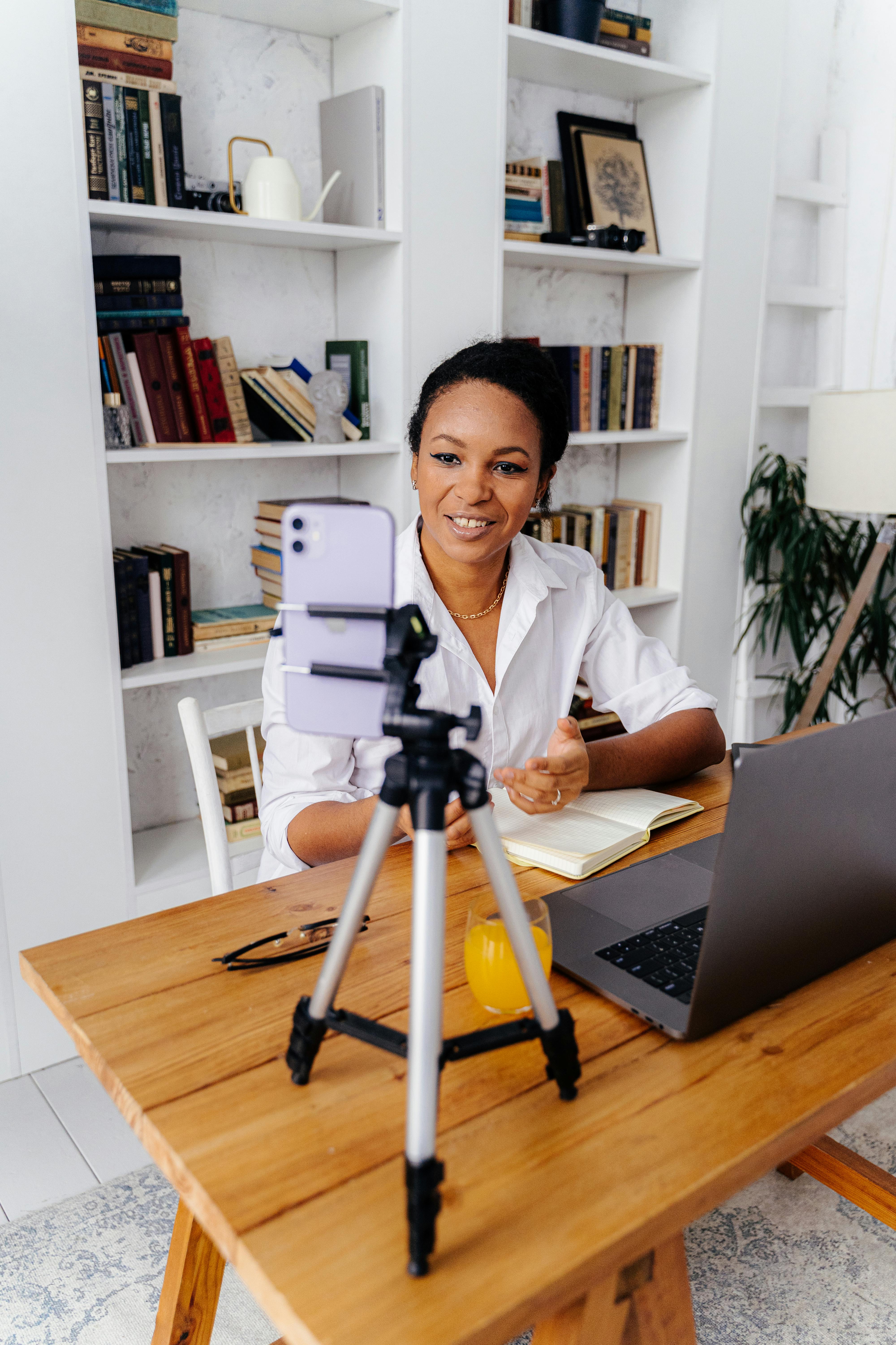 woman talking in front of smartphone on tripod