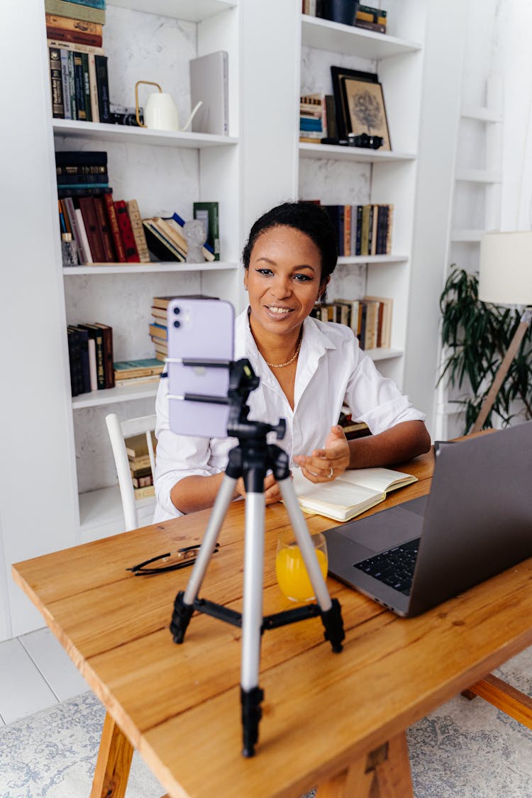 Woman Talking In Front Of Smartphone On Tripod