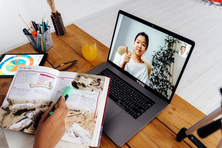 Person Teaching Girl On Laptop Screen 