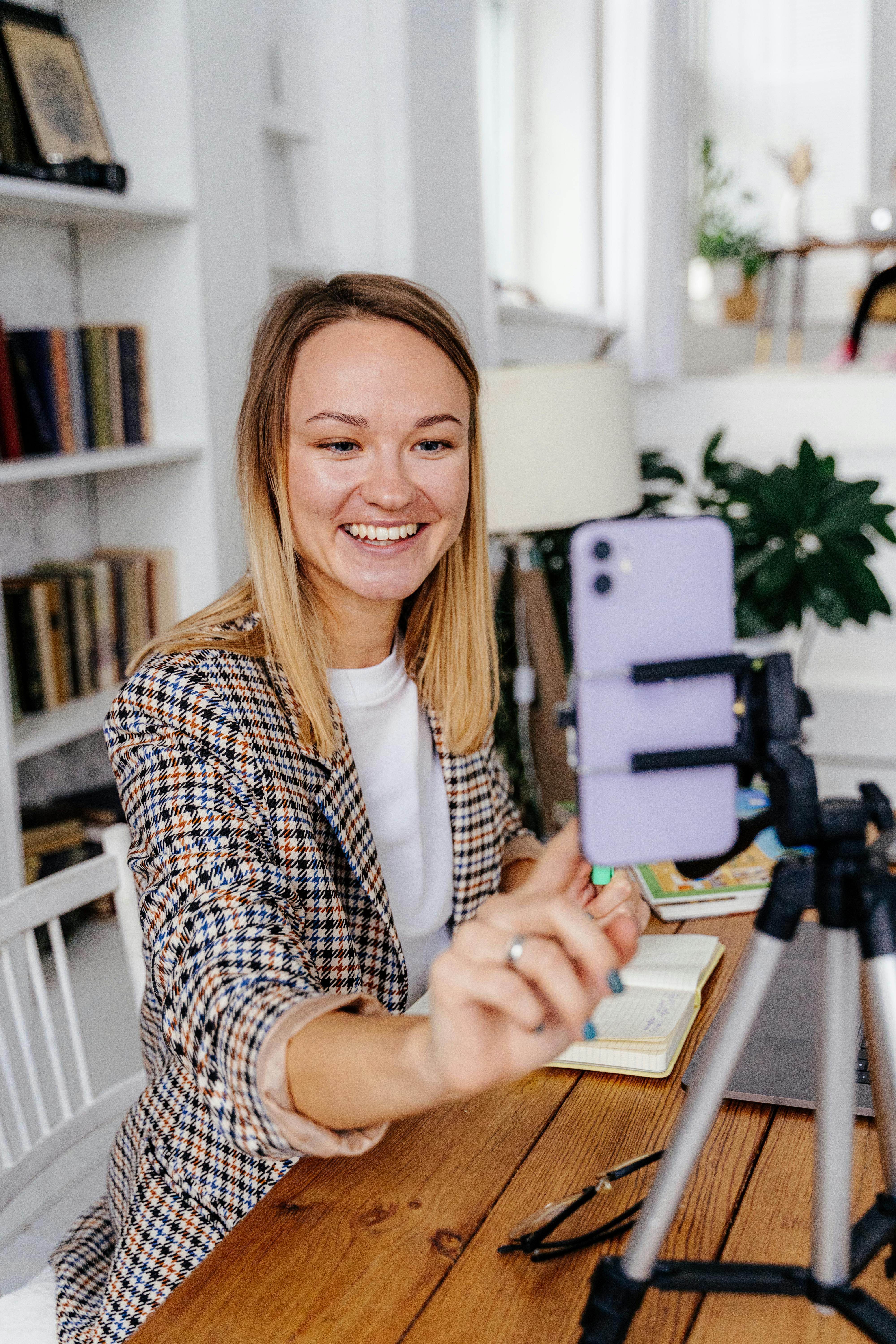 woman talking on a video call in a home office