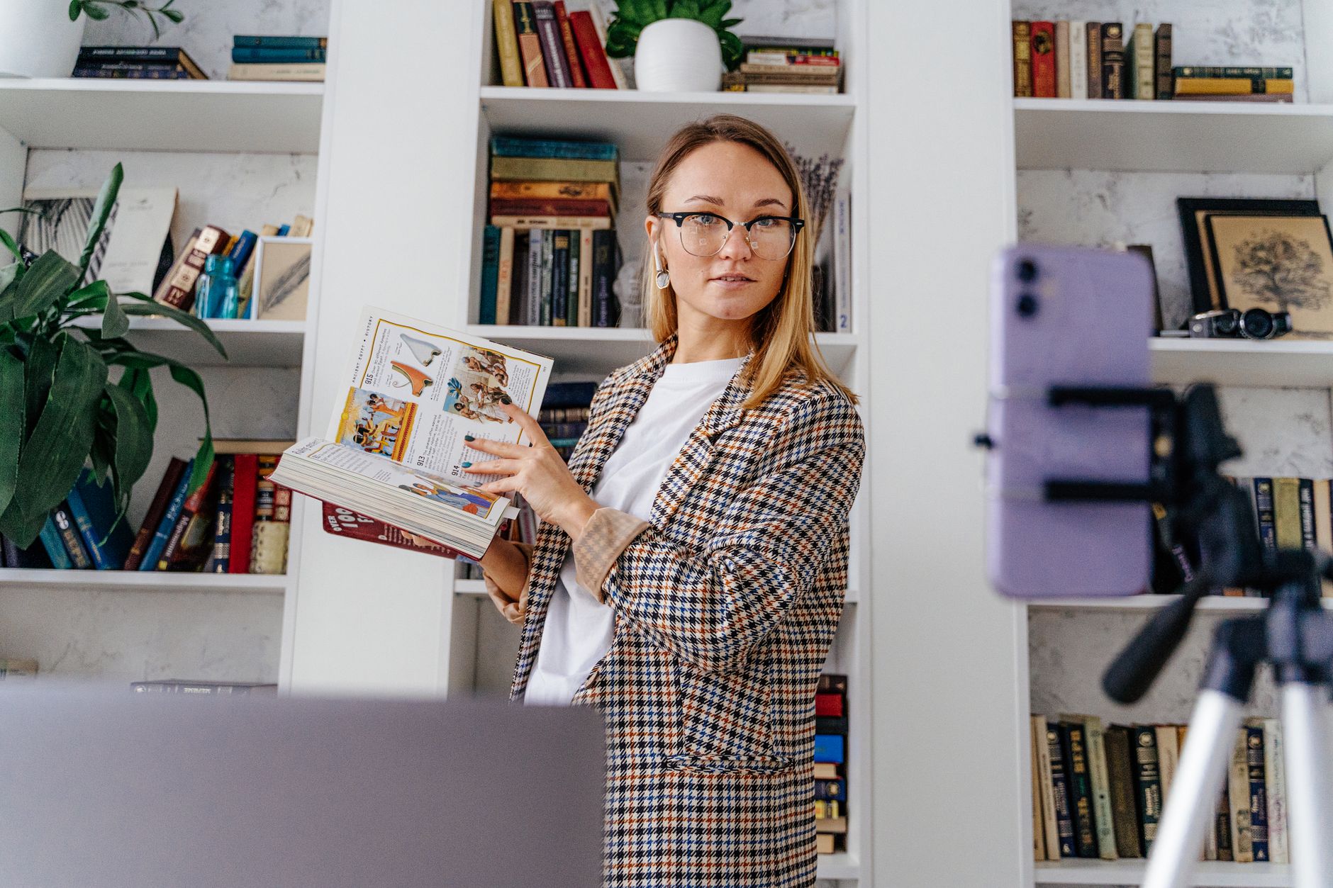 Woman conducting an online class from her home library