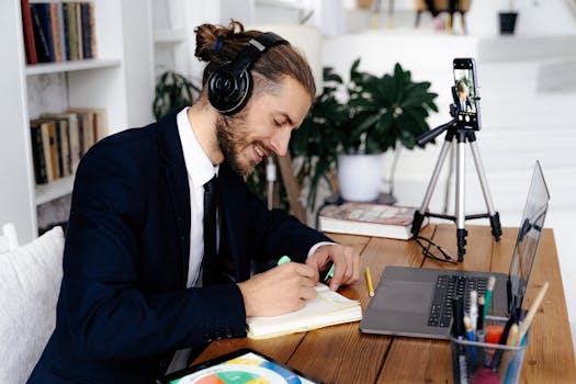 Man in headphones enjoying creative work and study session at home while video conferencing.