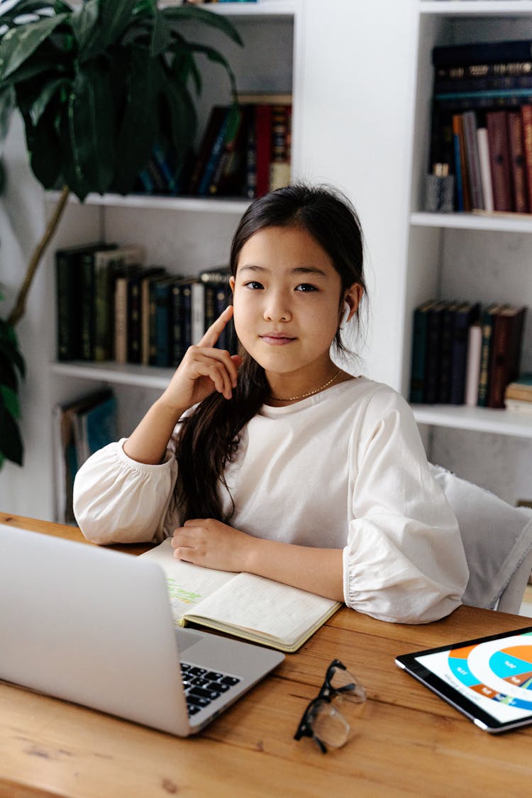 Teenager Studying By Desk With Laptop