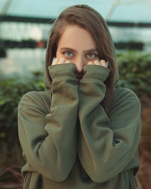 Woman in Gray Sweater Covering Her With Hands 