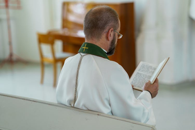 A Man Reading A Bible