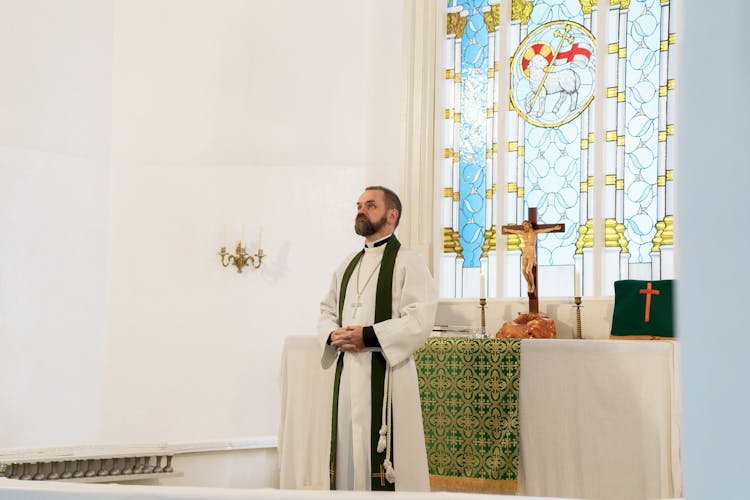 Priest Celebrating The Mass Inside A Church 