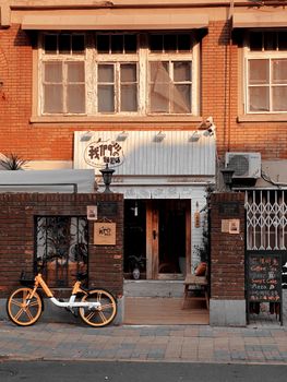 A quaint cafe entrance in Heping District, Tianjin with a bicycle parked outside.