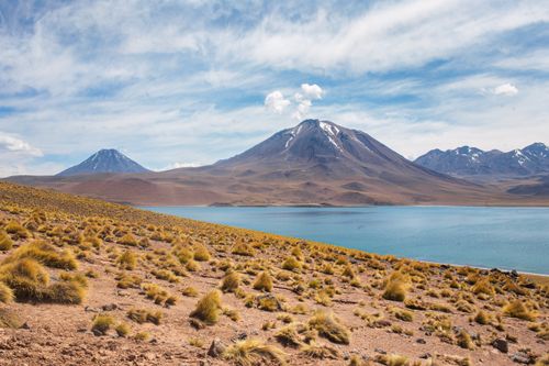Free Stunning view of Andean mountains and lake under a clear sky in Chile. Stock Photo
