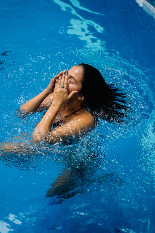 Woman in Water With Hands on Her Face