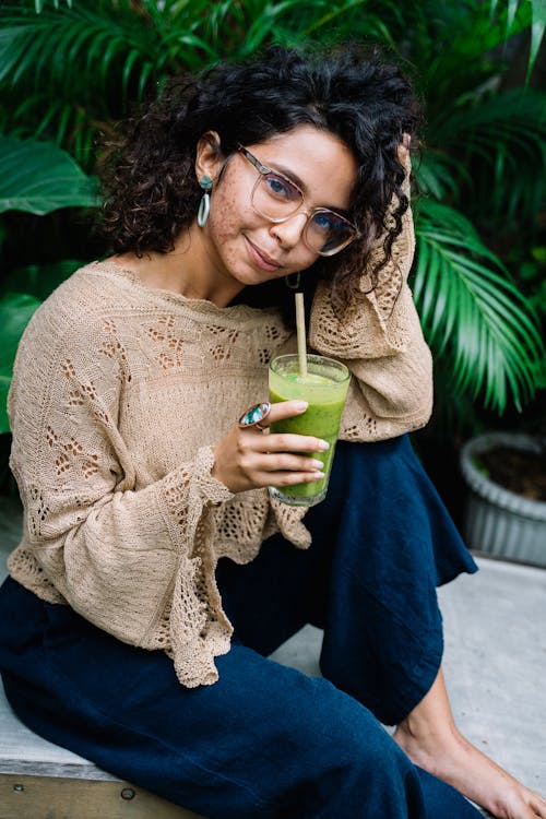 Woman Wearing a Beige Knitted Sweater