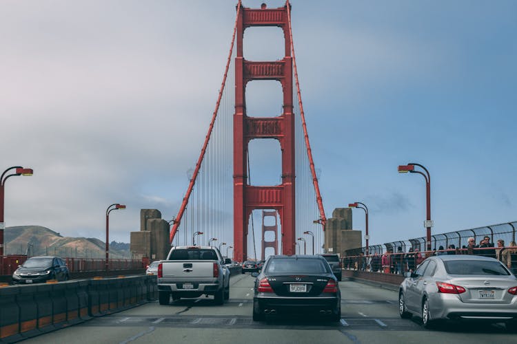 Cars On Golden Gate Bridge Under Cloudy Sky