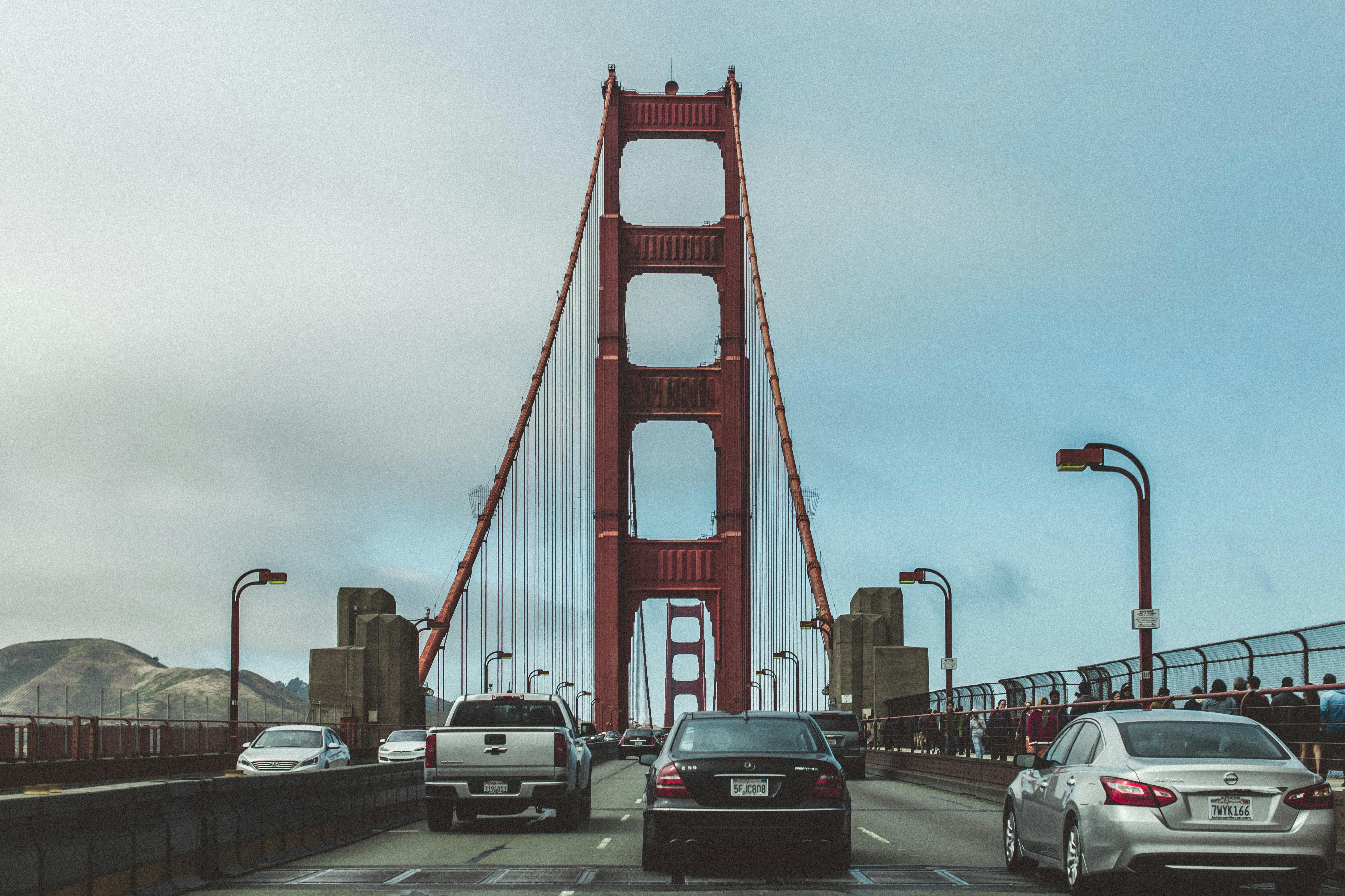 View of the Golden Gate Bridge with cars and pedestrians in San Francisco, CA.