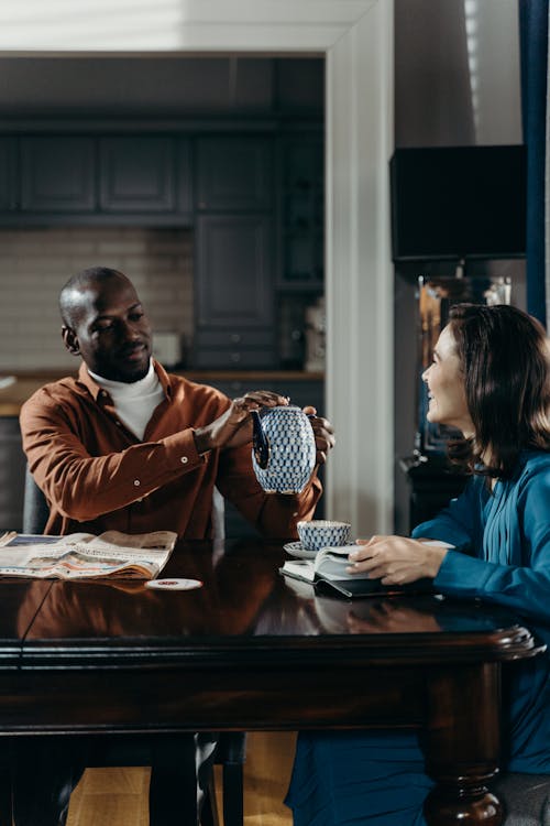 Man in Brown Long sleeves Holding a Tea Pot