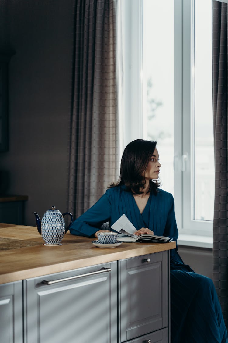 Woman In Blue Dress Reading A Book