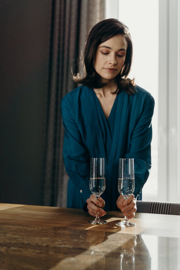 Woman Holding Glasses Of Champagne 