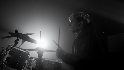 Free Black and White Photo of a Man Playing Drums Stock Photo