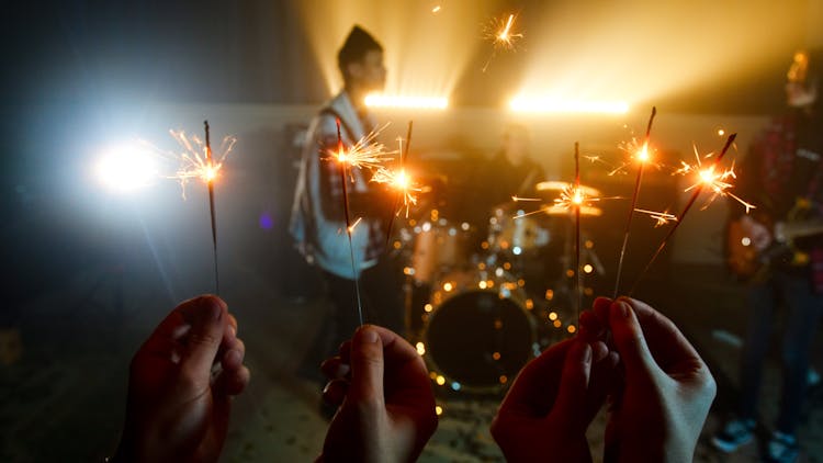 People Holding Burning Sparklers