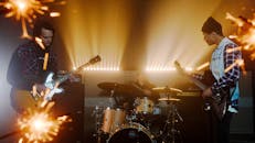 A Band Playing musical Instruments on Stage