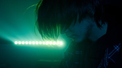 Man in Front of Green Neon Light 