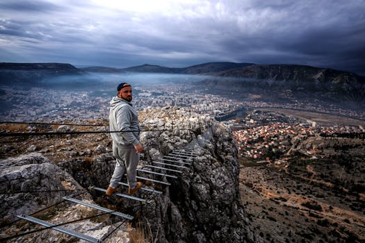 A man looks back while walking on a narrow mountain trail above Mostar, Bosnia.