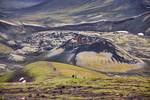 Free Tourists Hiking Towards Scenic Volcano Stock Photo
