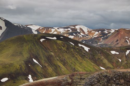 Free Breathtaking view of Iceland's colorful highlands, showcasing snow-capped peaks and lush greenery. Stock Photo