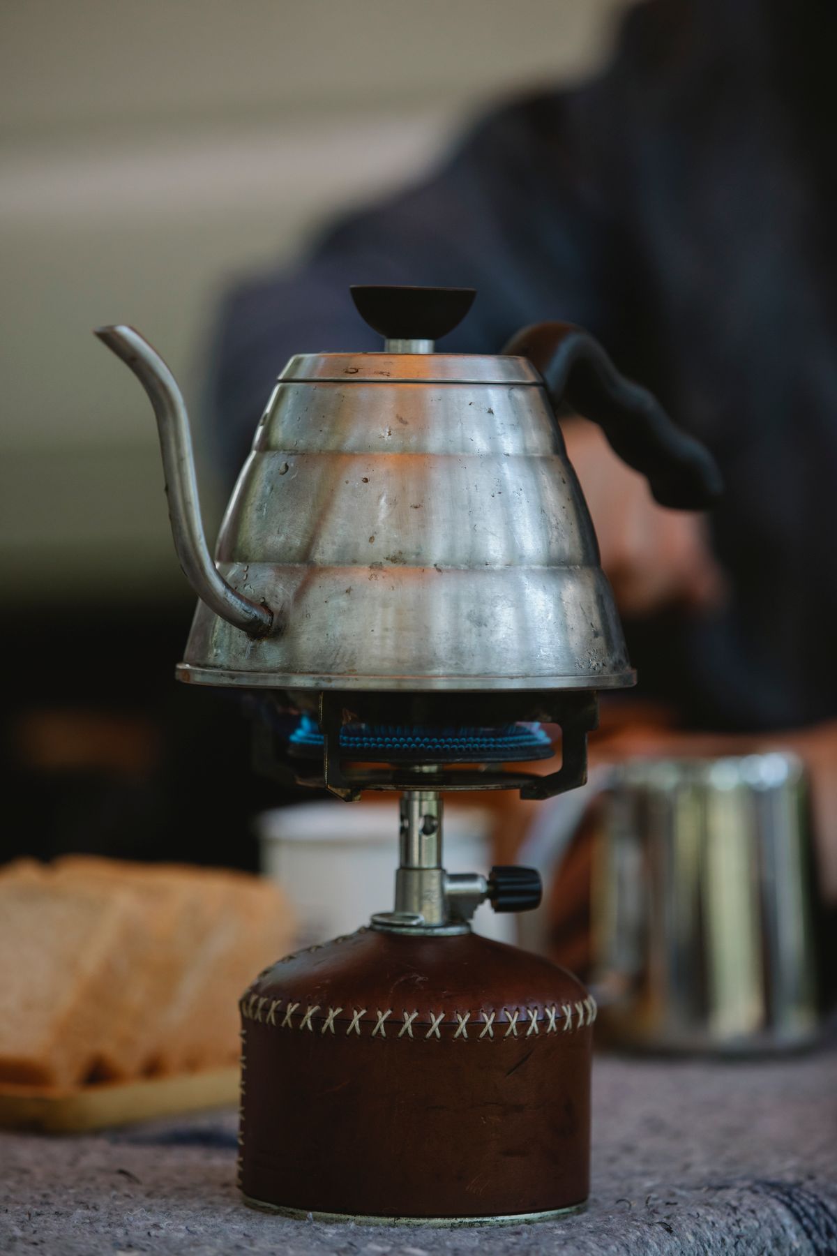 Kettle heating over a compact single-burner camping stove