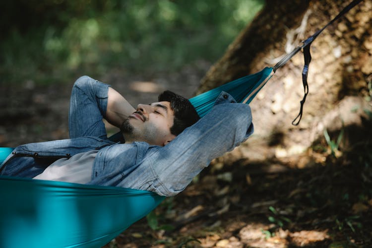 Dreamy Man Resting In Hammock In Woods