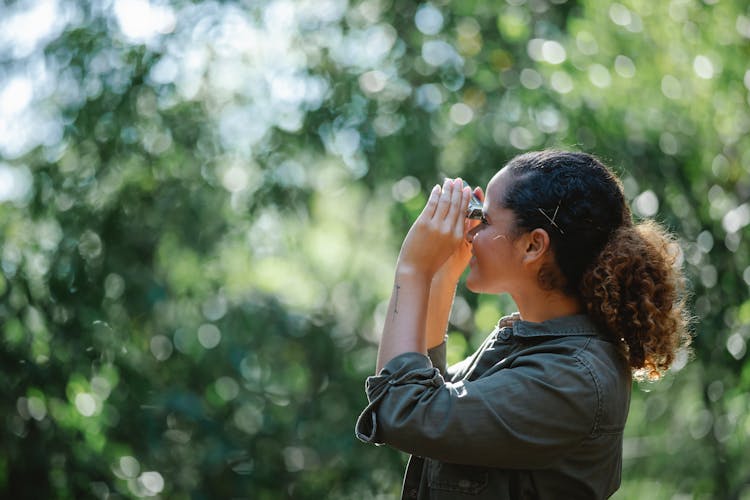 Delighted Ethnic Woman Looking At Binocular