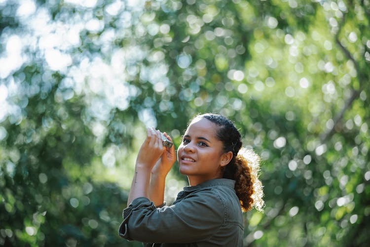 Glad Ethnic Woman With Binocular Looking Away