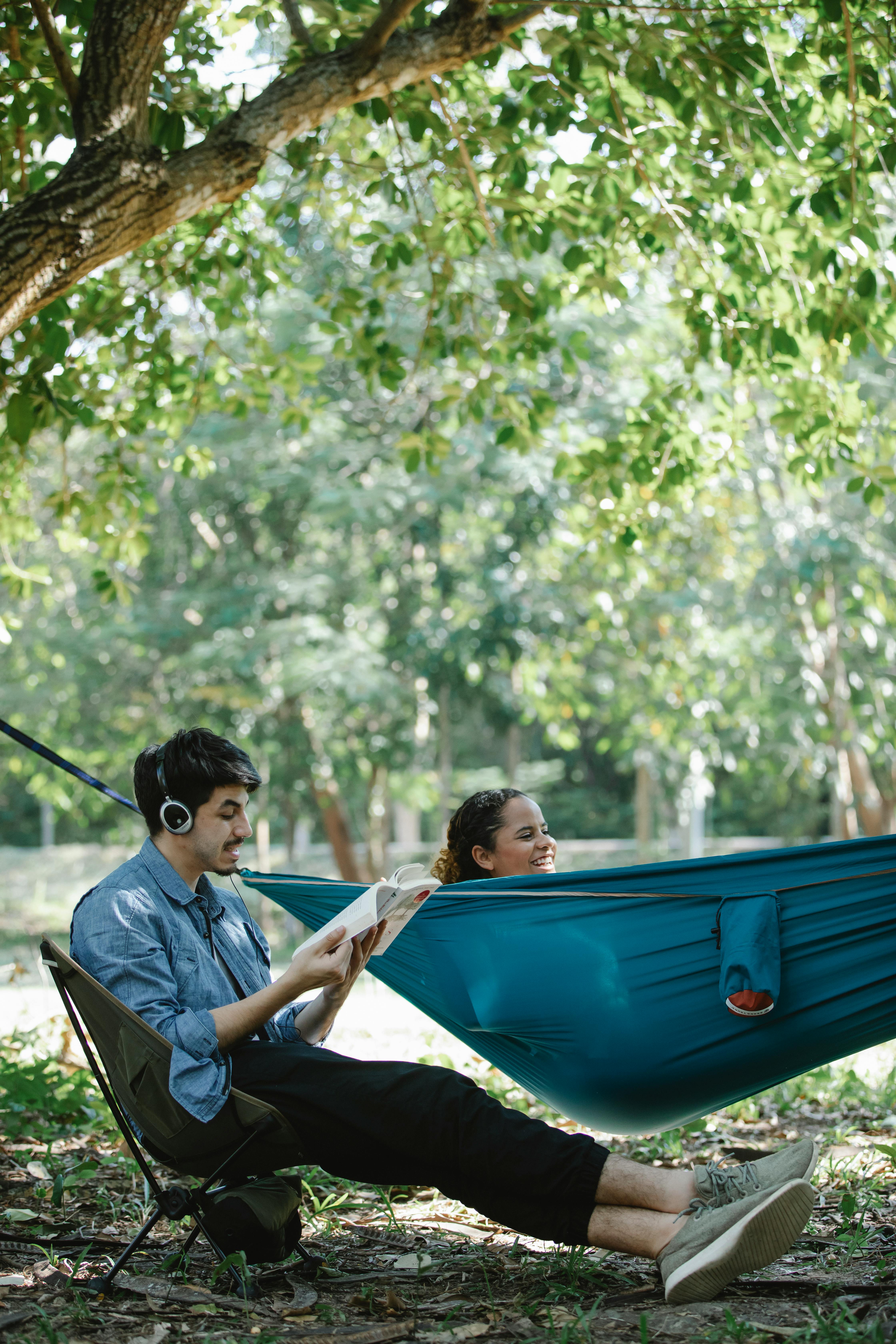 glad diverse couple spending time in woods