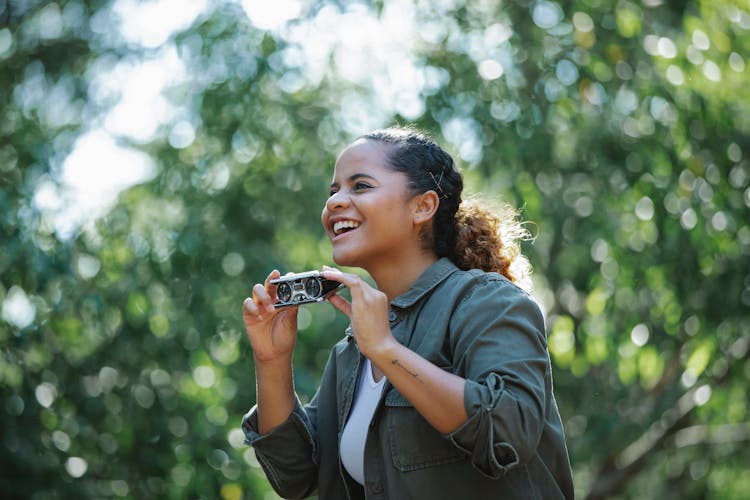 Cheerful Ethnic Woman With Small Binocular